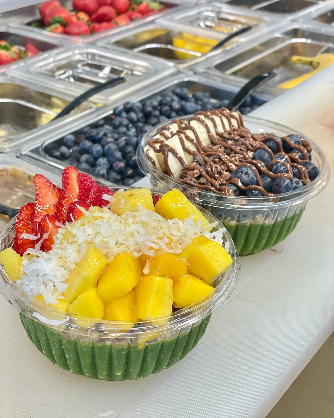 Colorful açaí bowl with mango, strawberry and coconut